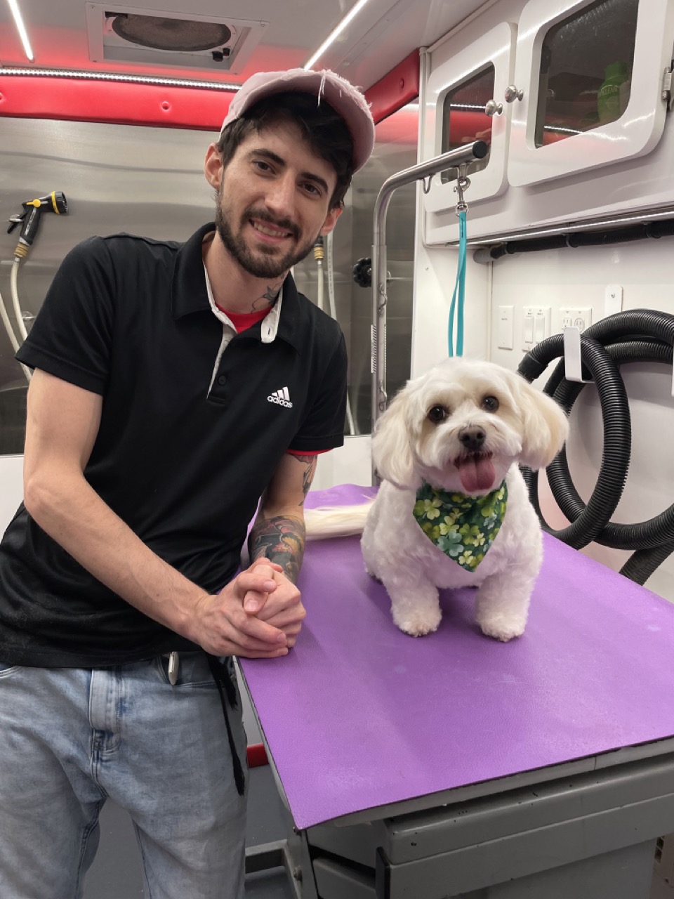 Ben with a freshly groomed dog in the mobile grooming van
