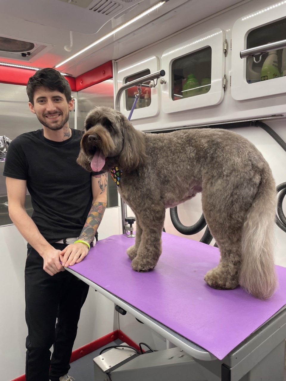 Ben holding a small dog inside the van