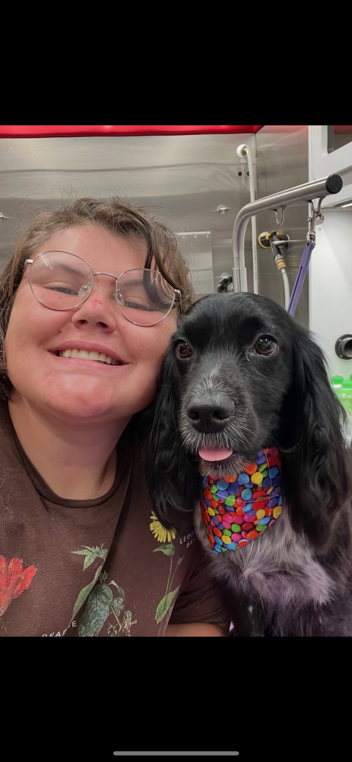 Wes smiling with a freshly groomed dog